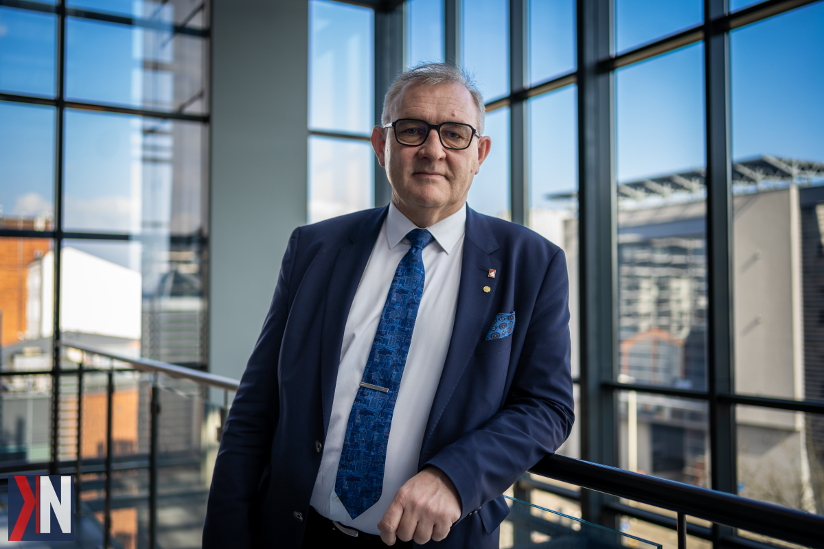 "Rektor Politechniki Łódzkiej podczas konferencji prasowej omawia rozbiórkę dawnego Wydziału Chemicznego, zaznaczając, że budynku nie da się zachować. W tle widać fragmenty rozbiórki, co wywołało protesty wśród mieszkańców i architektów związanych z łódzkim środowiskiem."